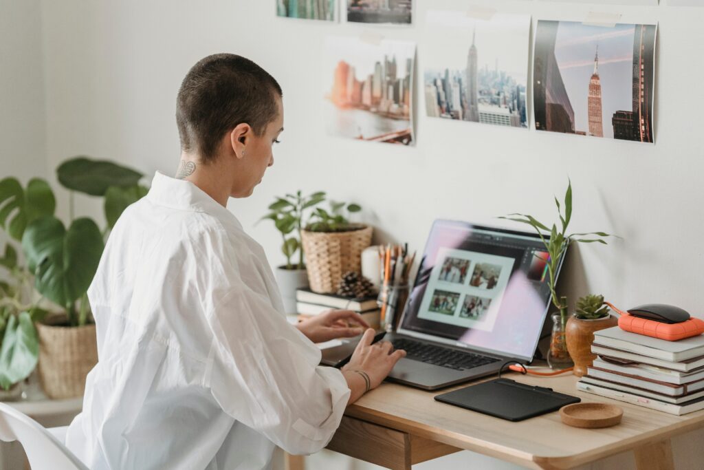 woman editing photos on a laptop